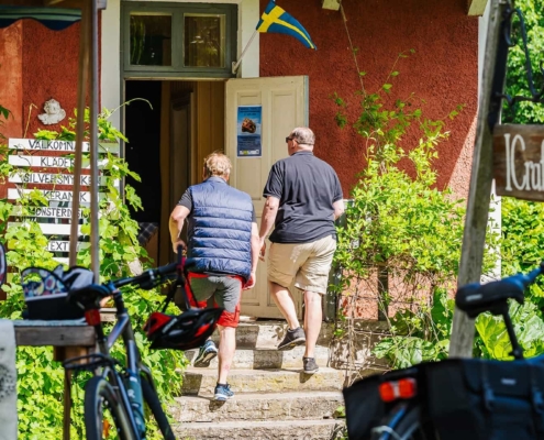 Two persons walking into a shop