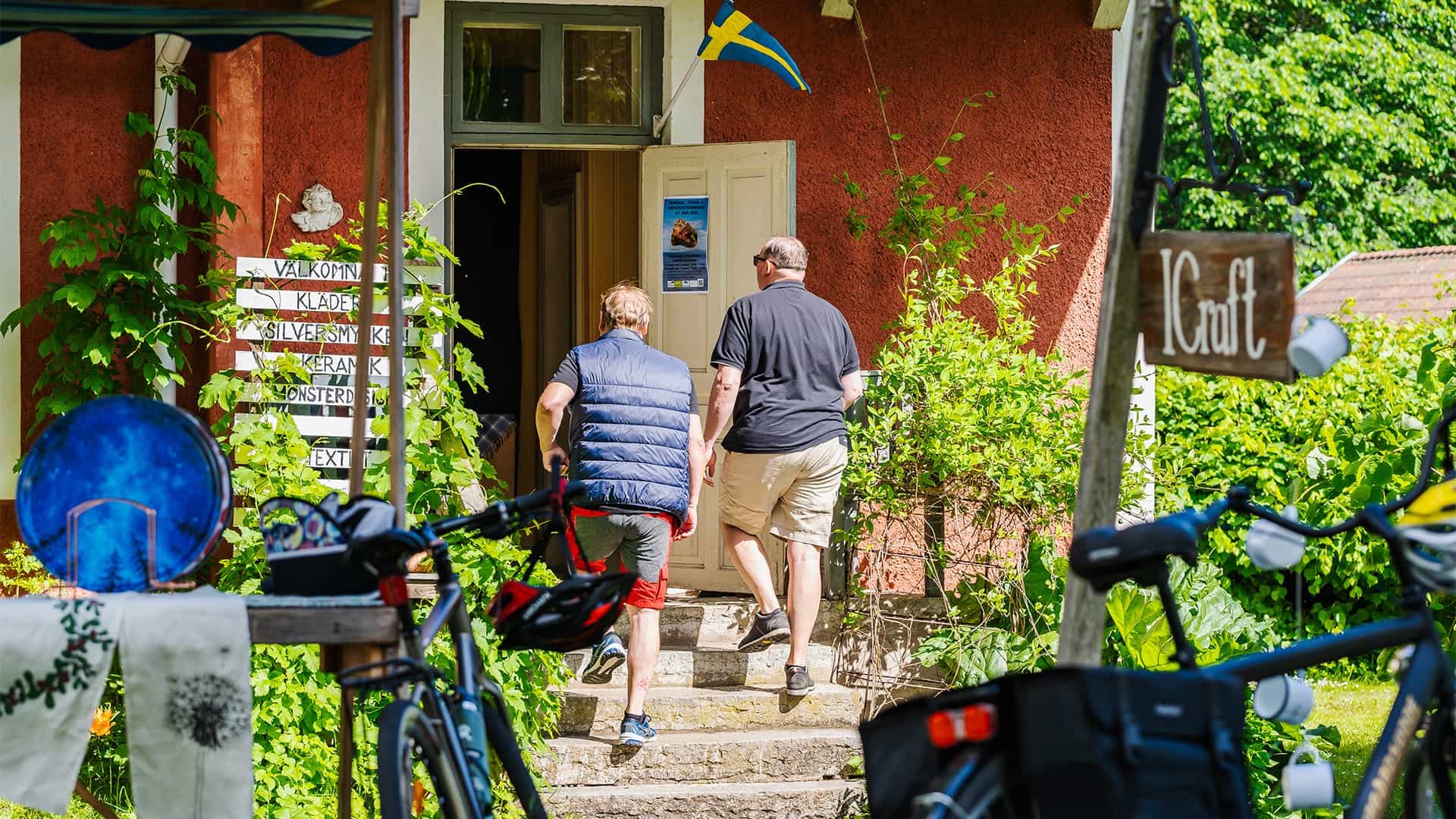 Two persons walking into a shop