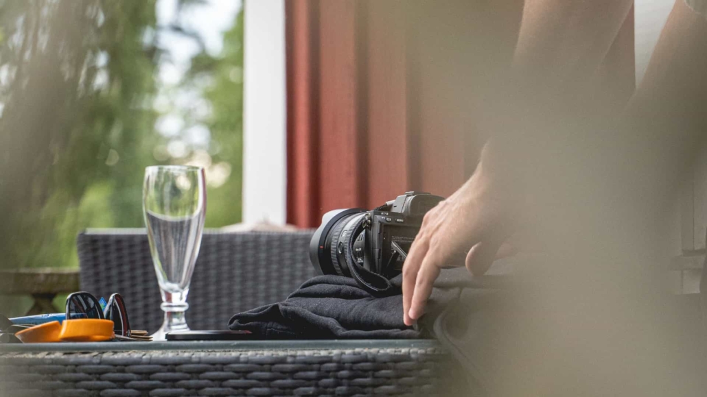 behind the scenes image of a person filming a glass