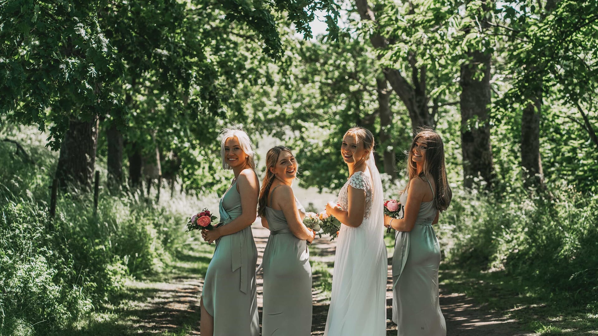 wedding bride with bridesmaids in a forest