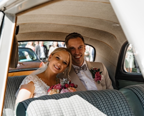 wedding couple inside of an old classic car