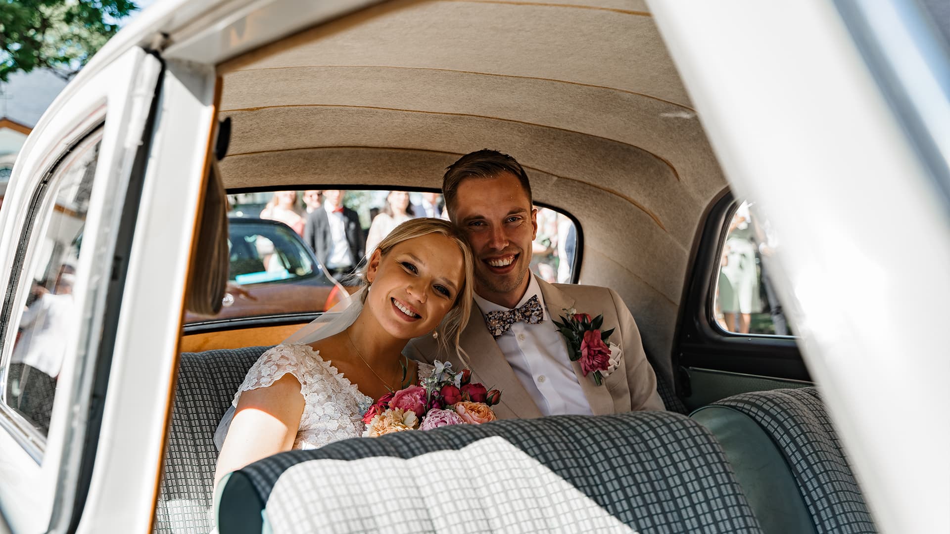 wedding couple inside of an old classic car