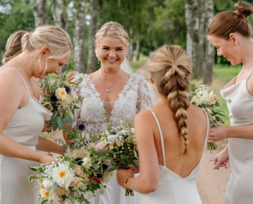 wedding bride laughing with bridesmaids