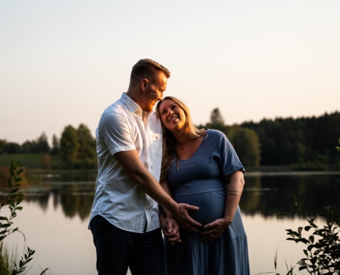 man and pregnant woman looking happy