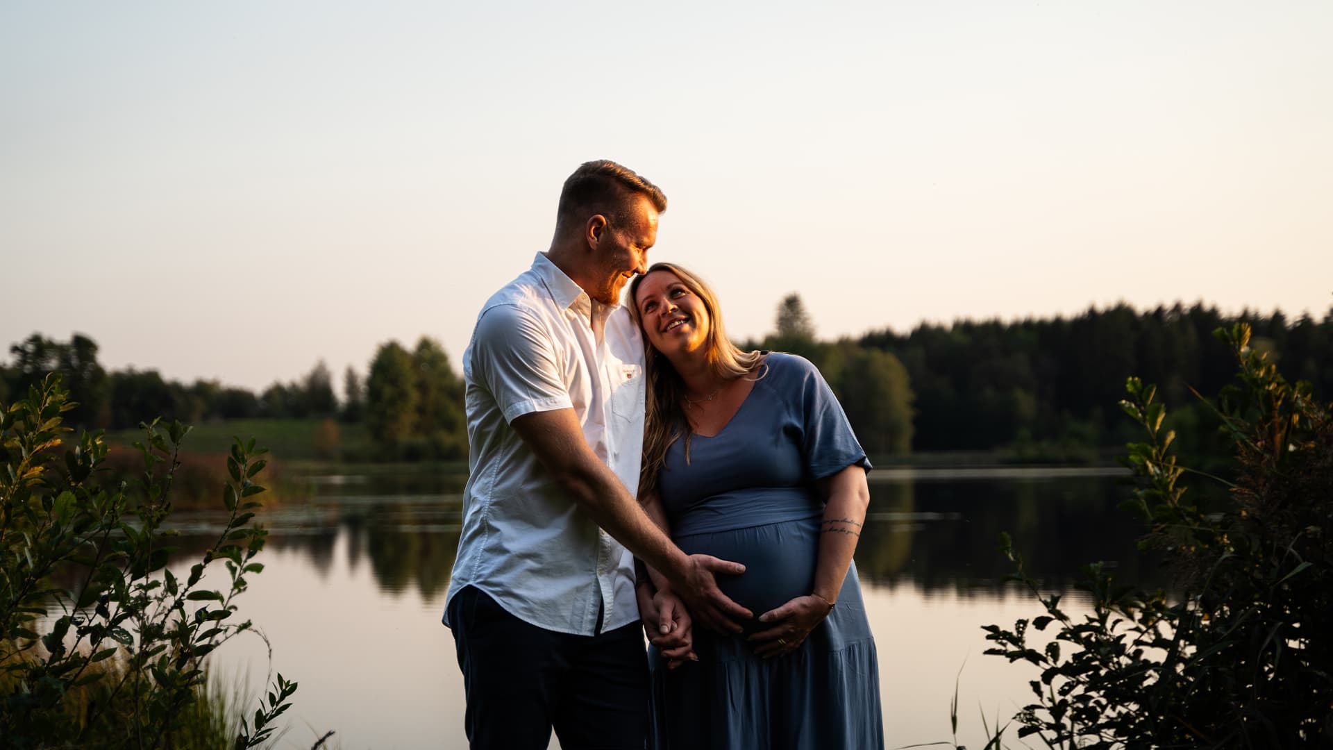 man and pregnant woman looking happy