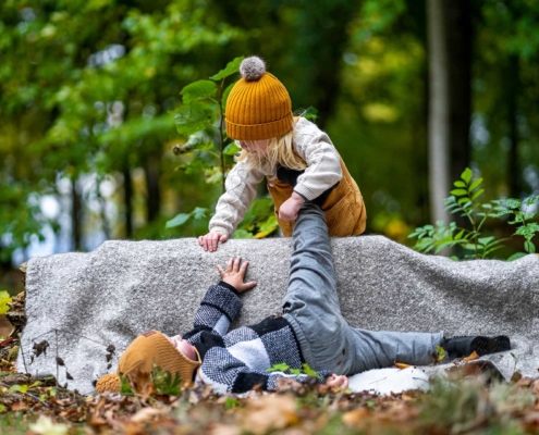 two kids playing in a forest