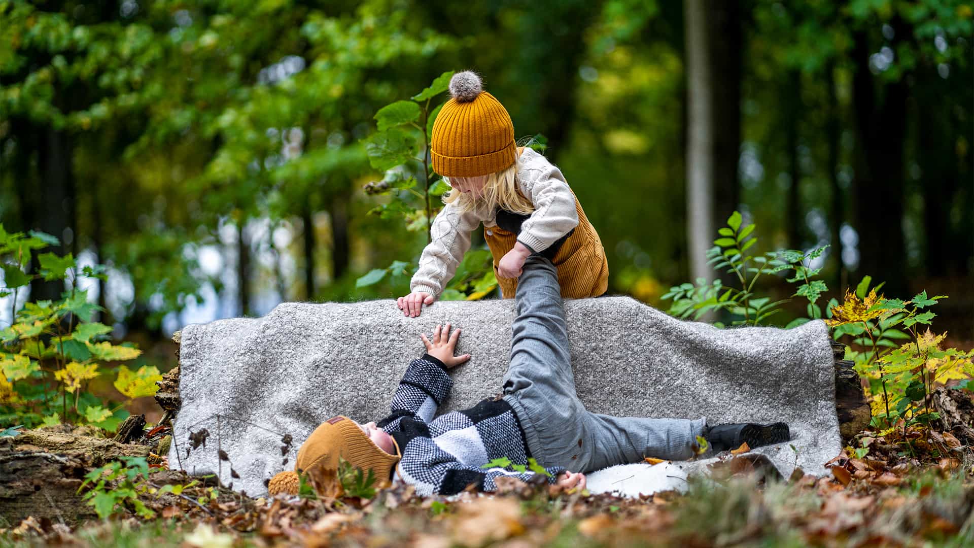 two kids playing in a forest