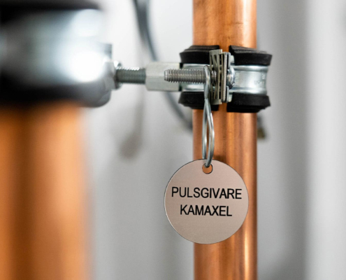 close up of a tag on a pipe