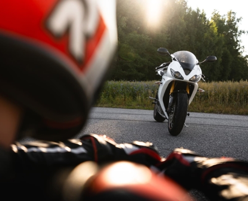 Person looking at a sportbike during sunset
