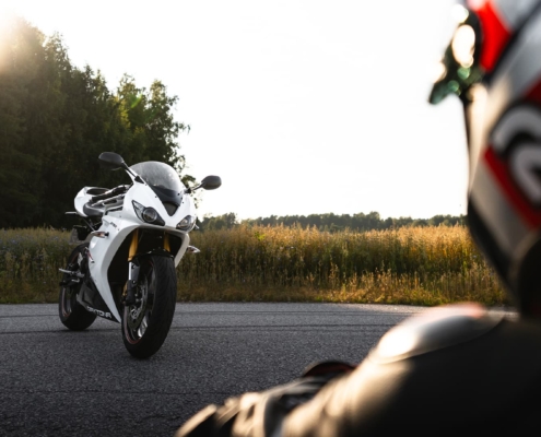 Person looking at a sportbike during sunset