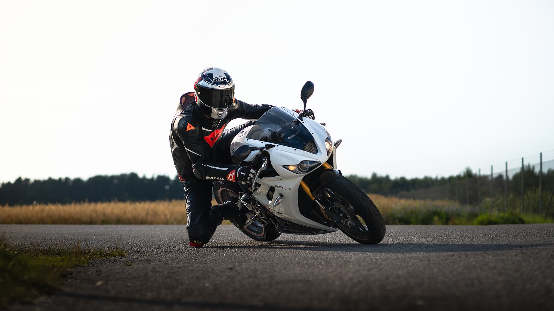 Person driving a sportbike during sunset