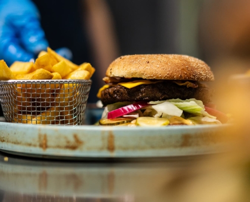close up of a plate with a burger and french fries