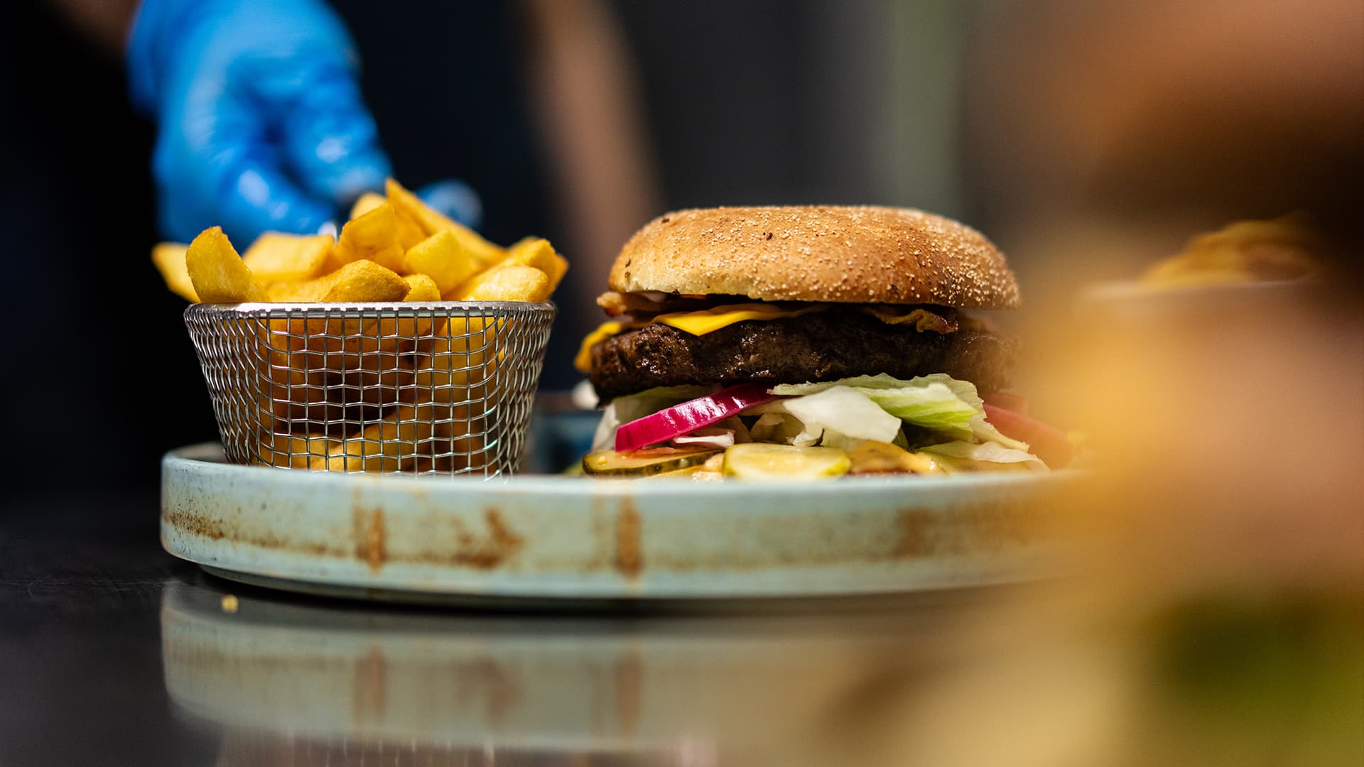 close up of a plate with a burger and french fries