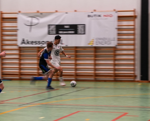 futsal player running with the ball during a game
