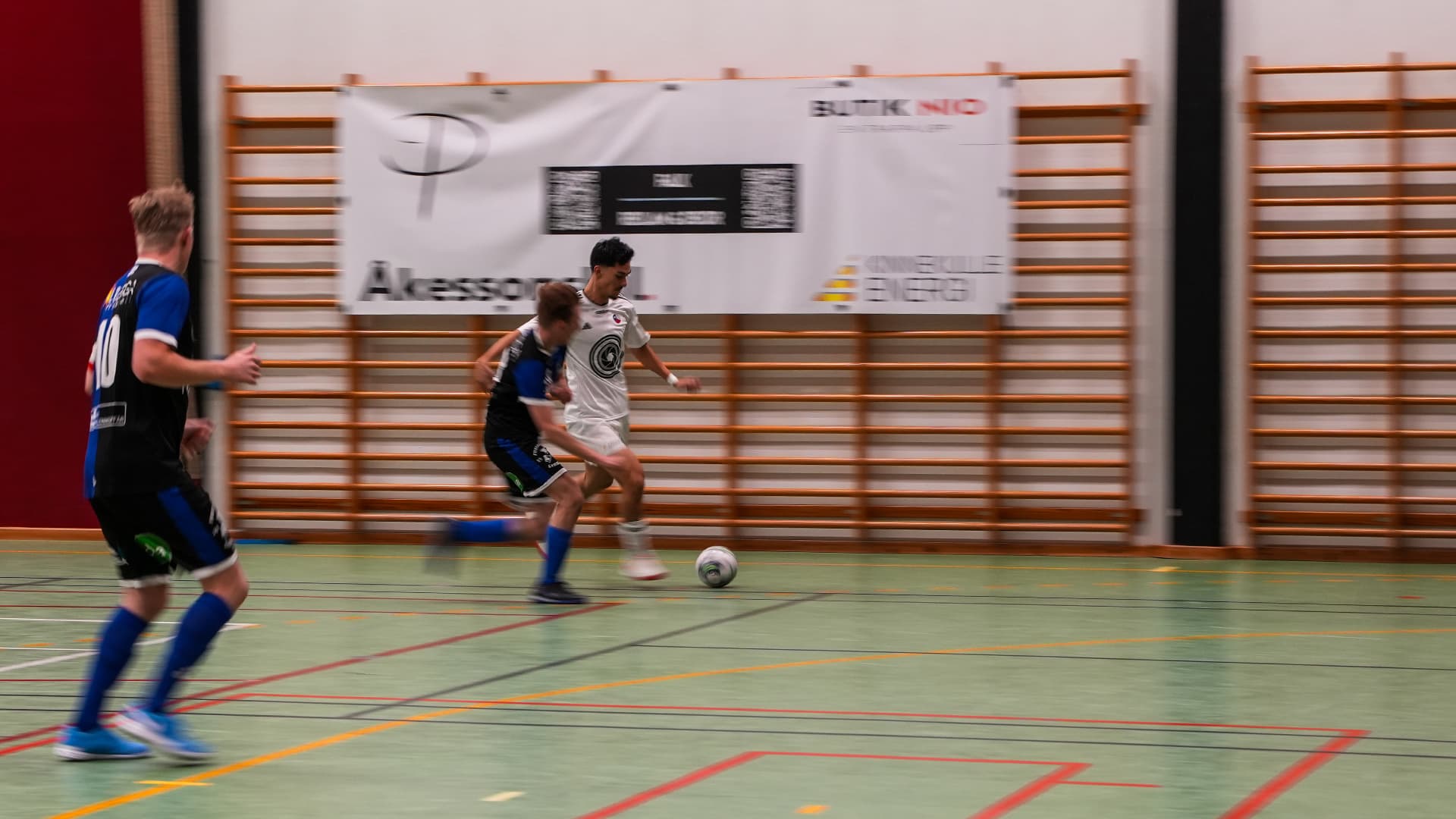 futsal player running with the ball during a game
