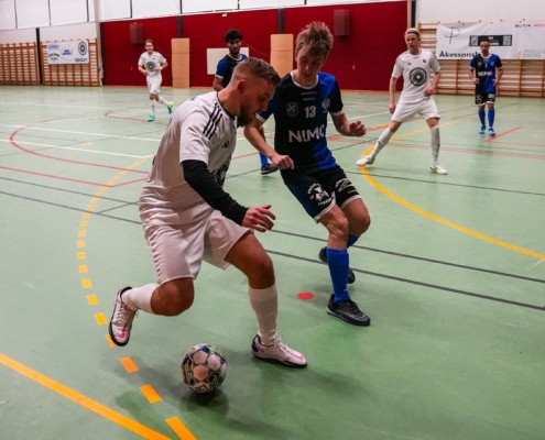 futsal player covering the ball during a game
