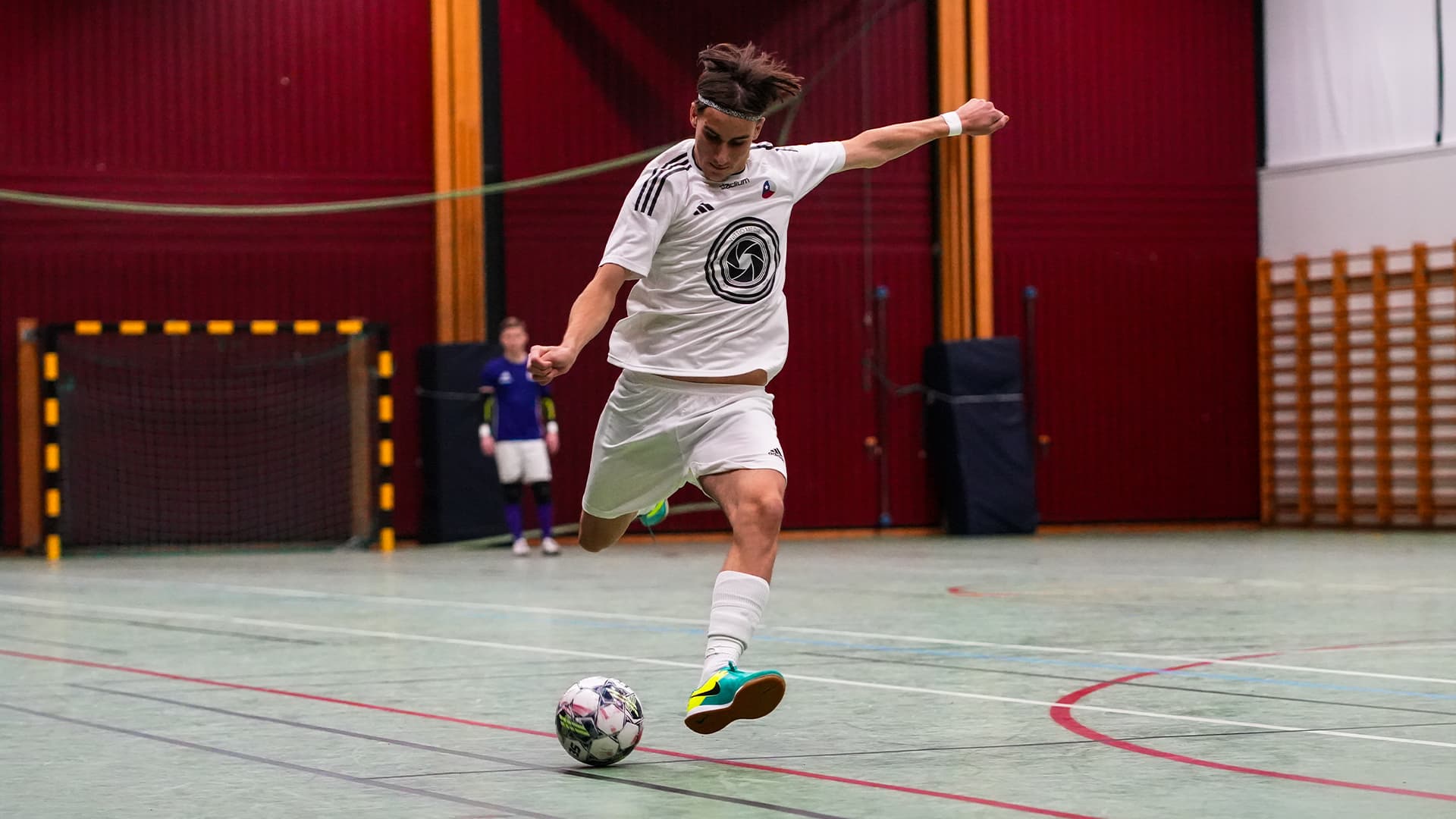 futsal player taking a shot during a game