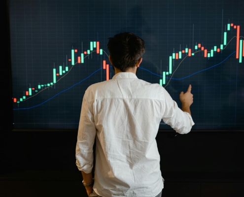 Person standing in front of a dashboard looking at a graph