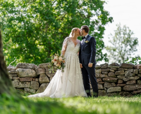 bride and groom kissing outdoors