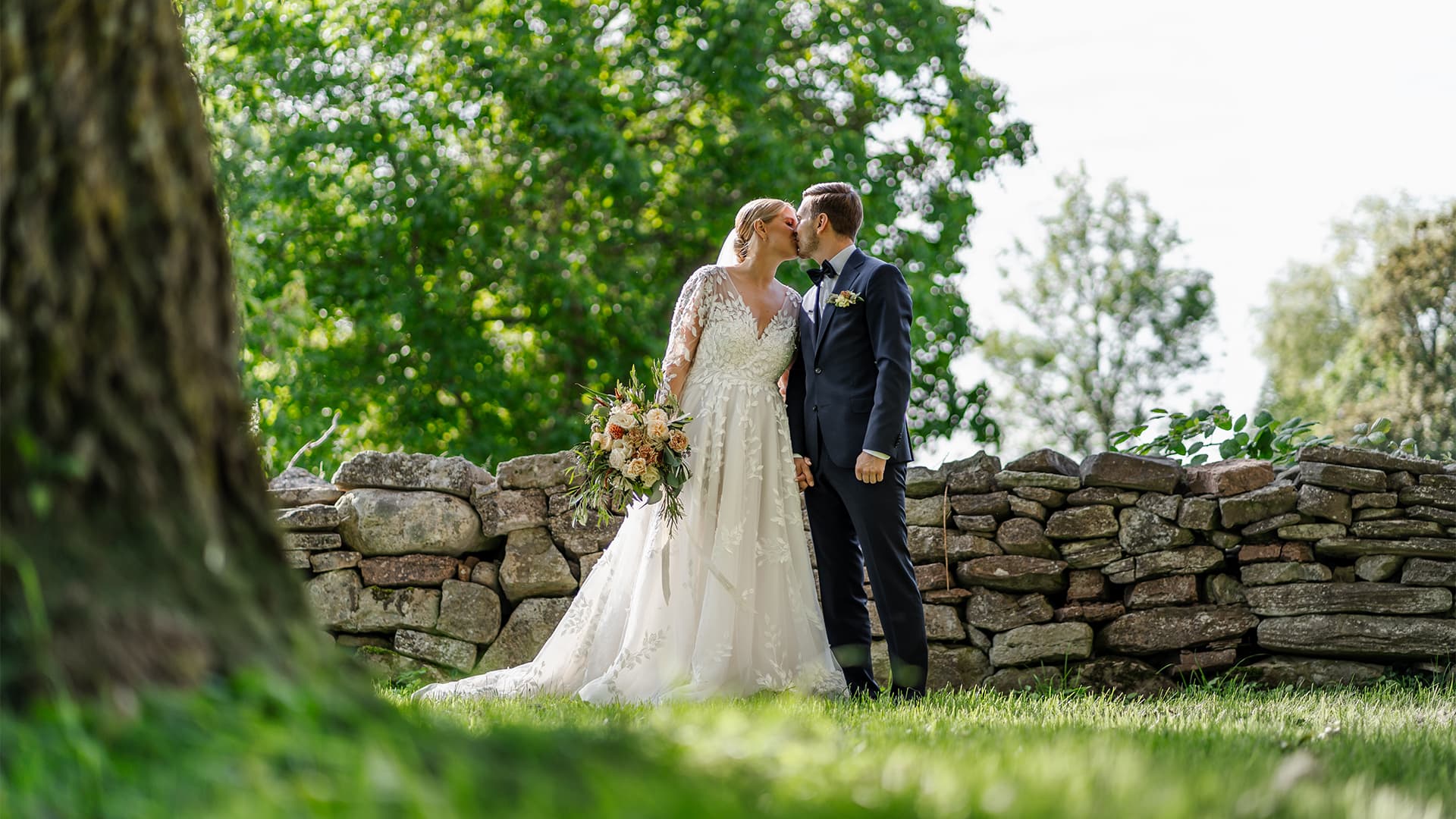 bride and groom kissing outdoors