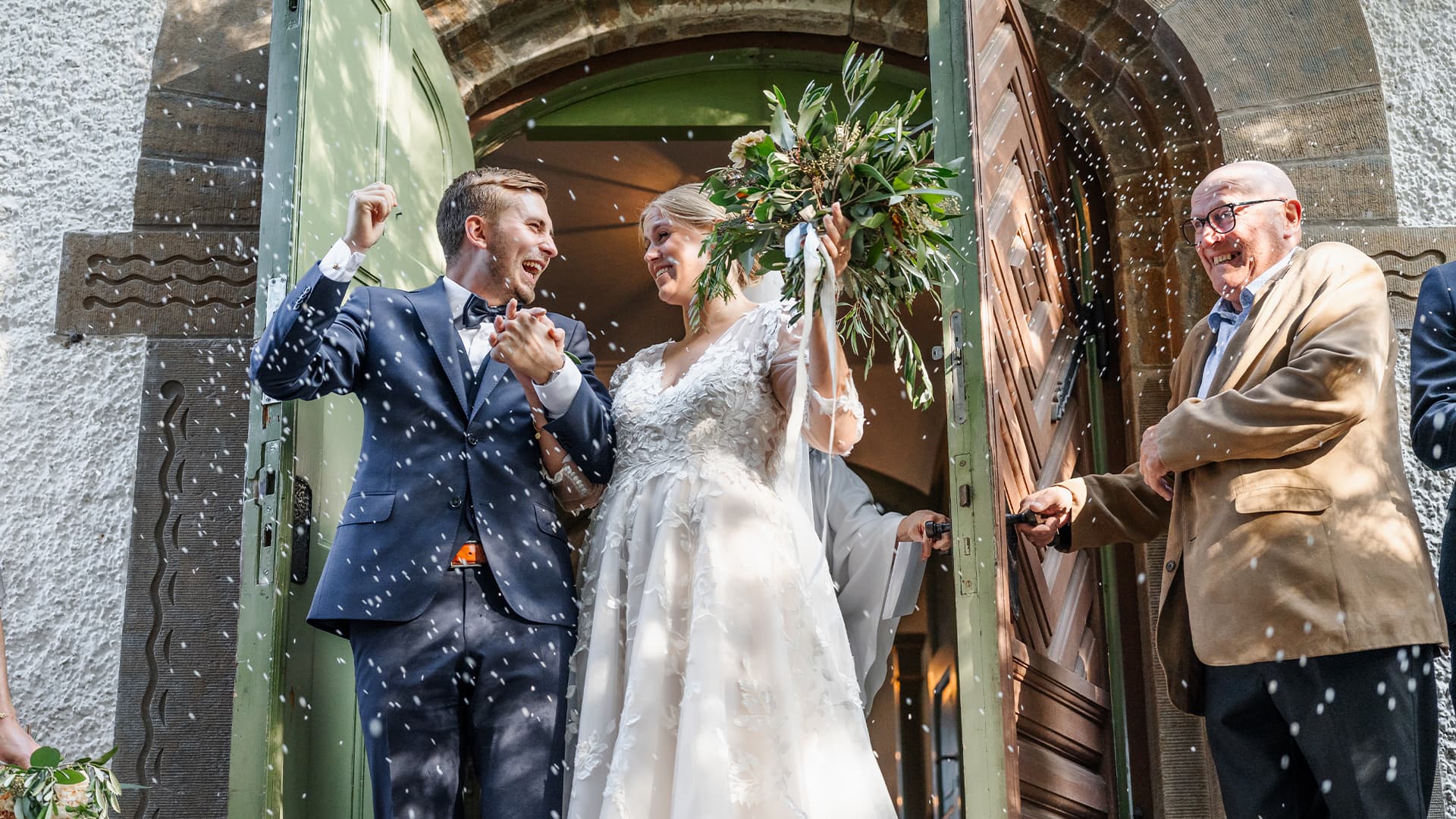 bride and groom walking out of the church