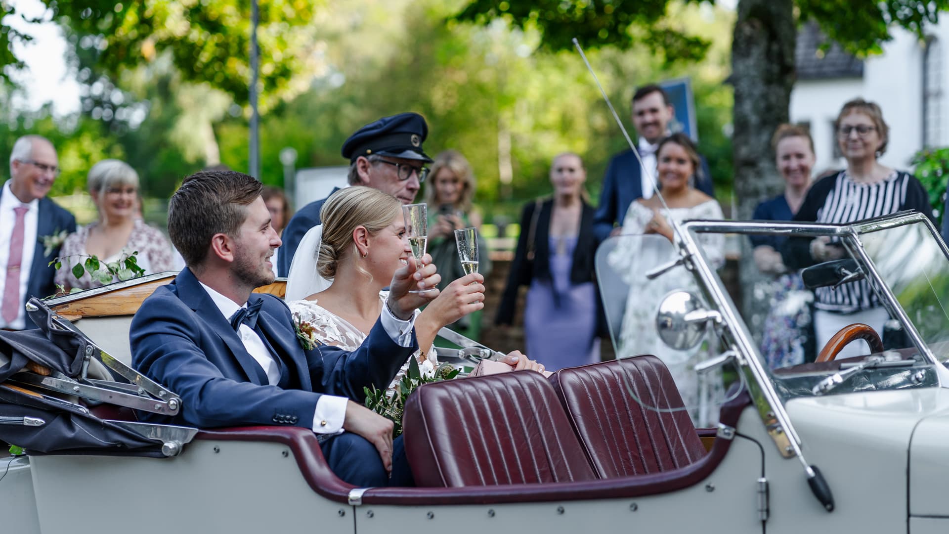 bride and groom doing a toast in the car outside of the church