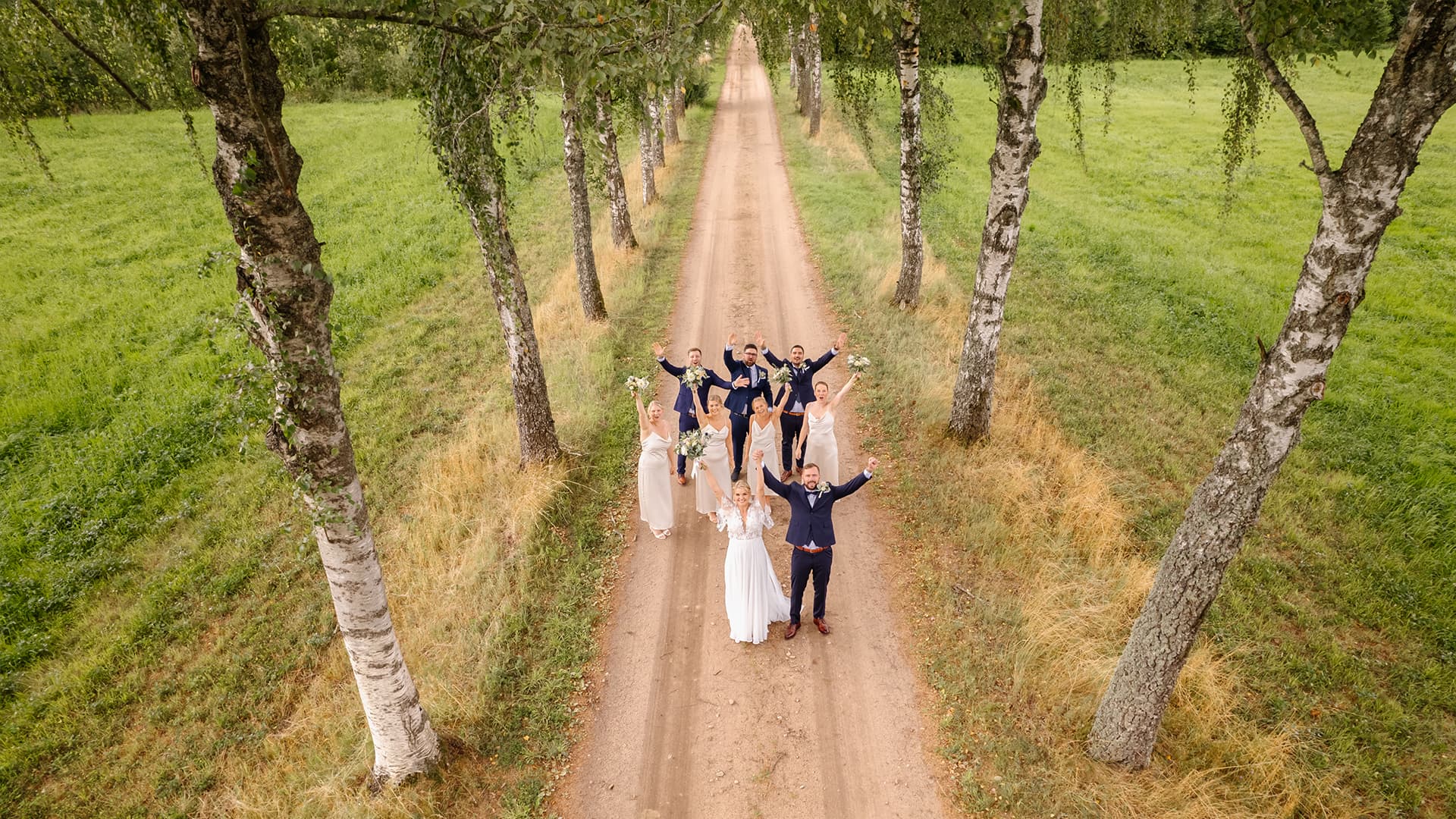 drone shot from above of bride and groom with their entourage