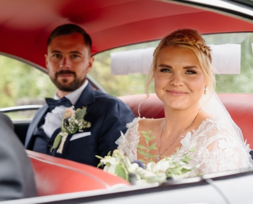 bride and groom in the car after their wedding