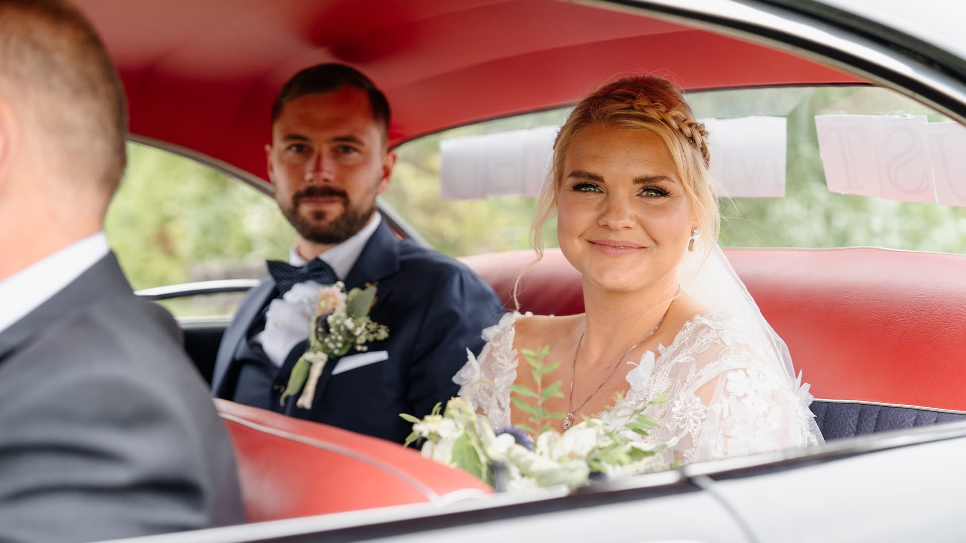 bride and groom in the car after their wedding