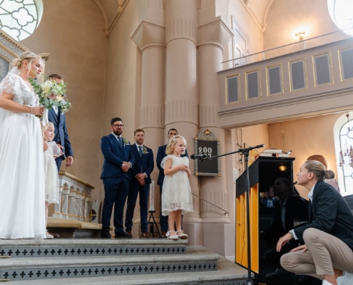 bride and groom's kid performing in the church