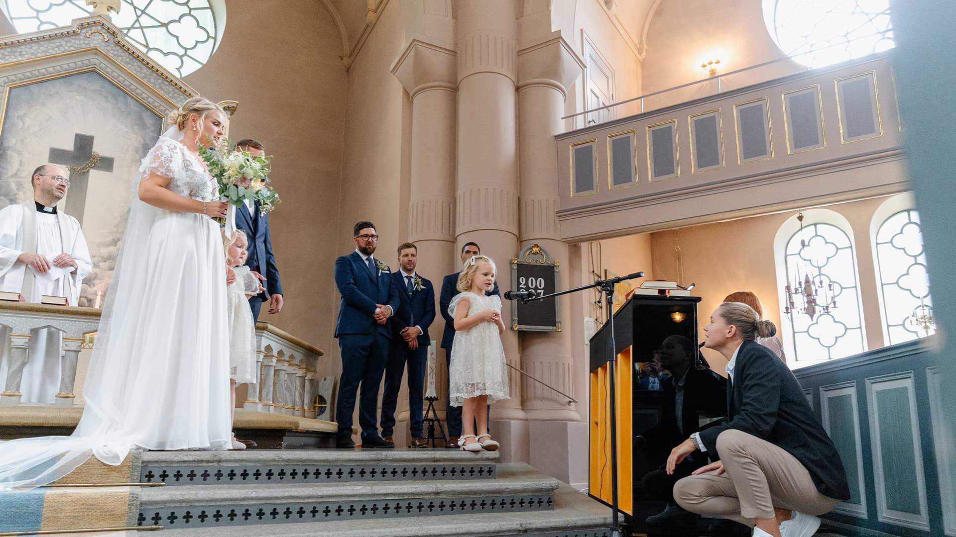 bride and groom's kid performing in the church