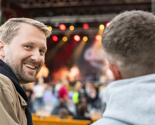 guy laughing at the camera at a concert