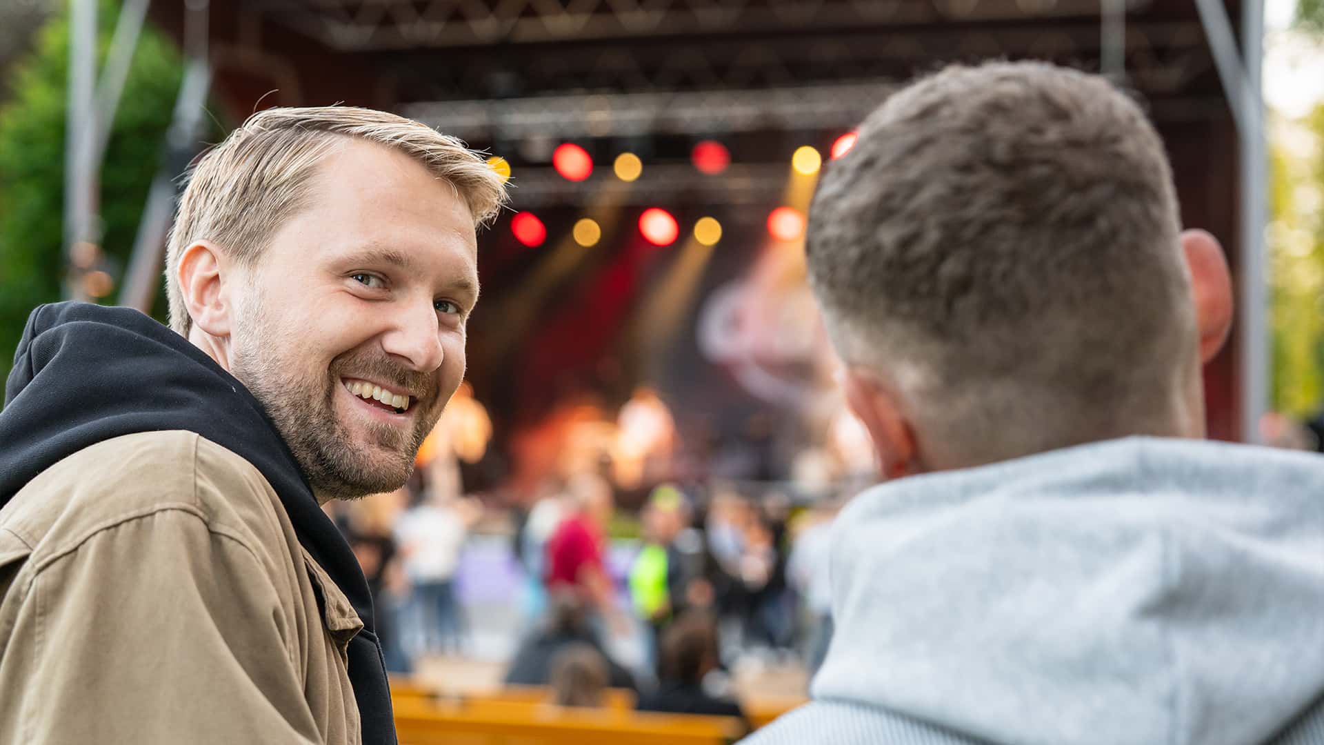 guy laughing at the camera at a concert