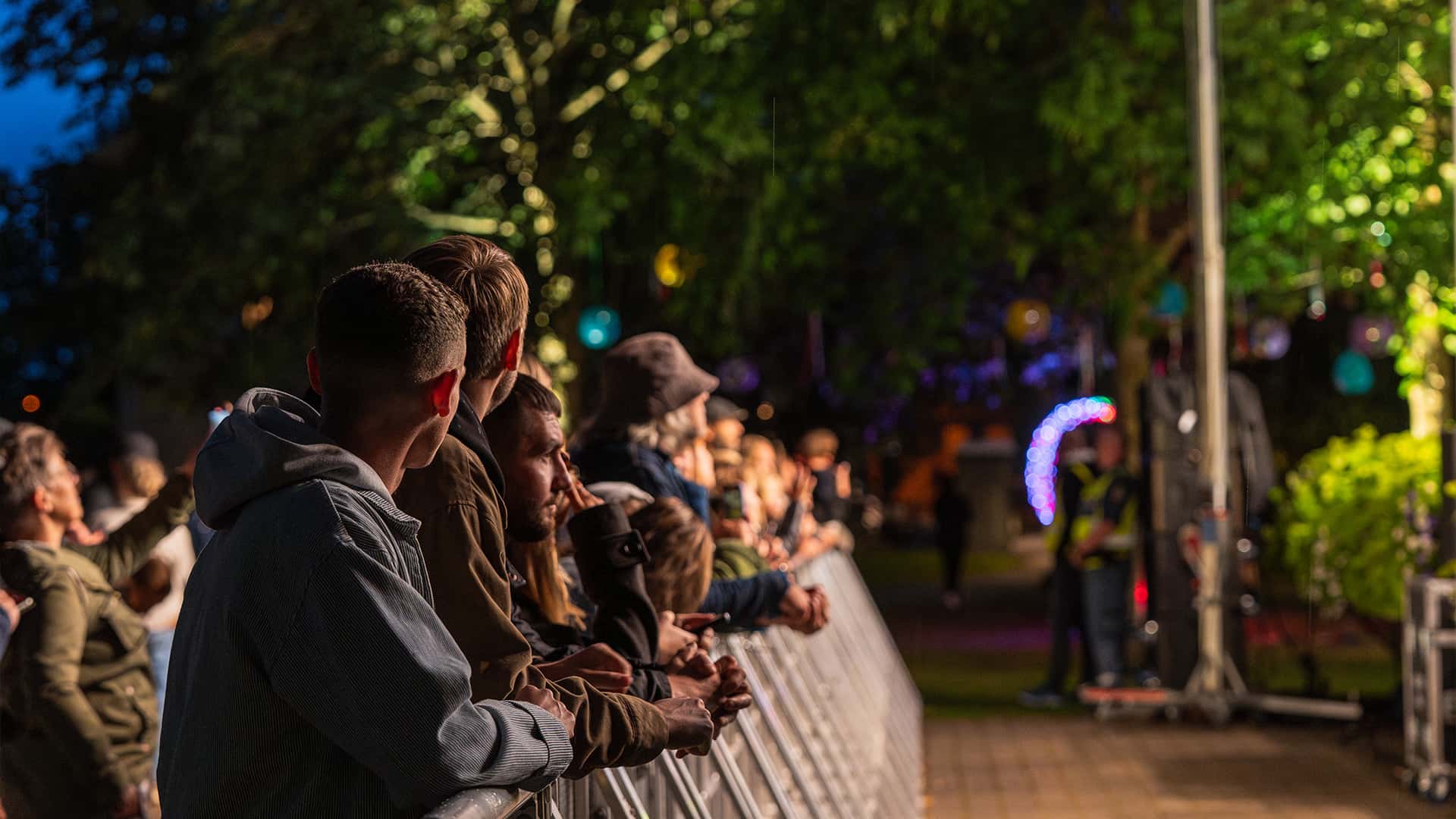 crowds in the front row at an evening concert