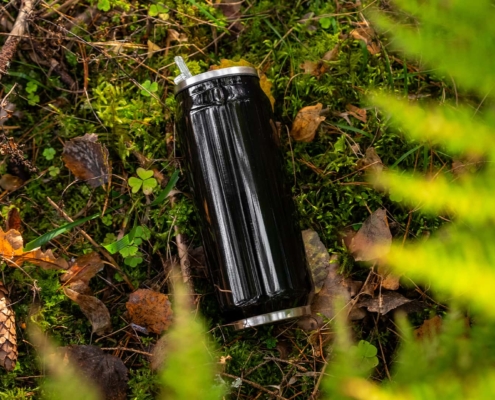 water bottle in silver shot in the forest