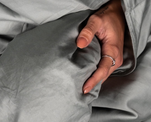 close up of a hand in a duvet