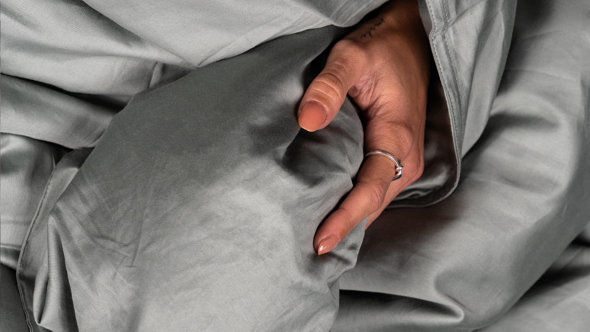 close up of a hand in a duvet