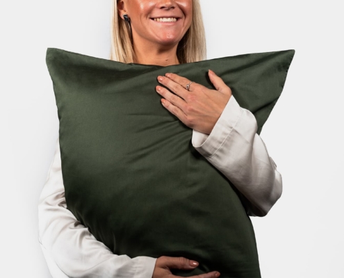 woman model holding a pillow and smiling