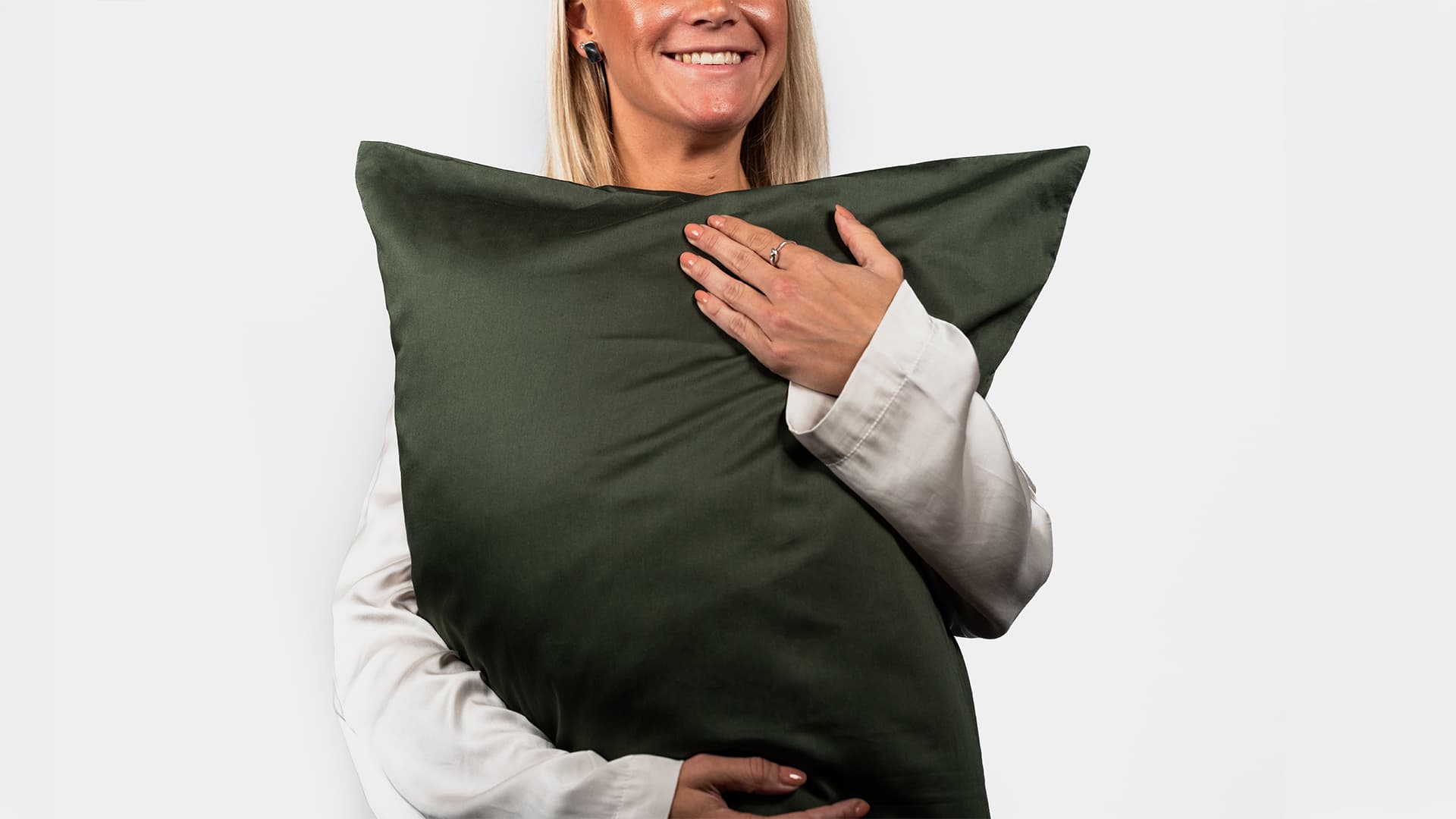 woman model holding a pillow and smiling