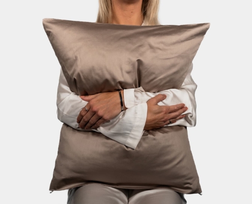 woman model holding a pillow while sitting