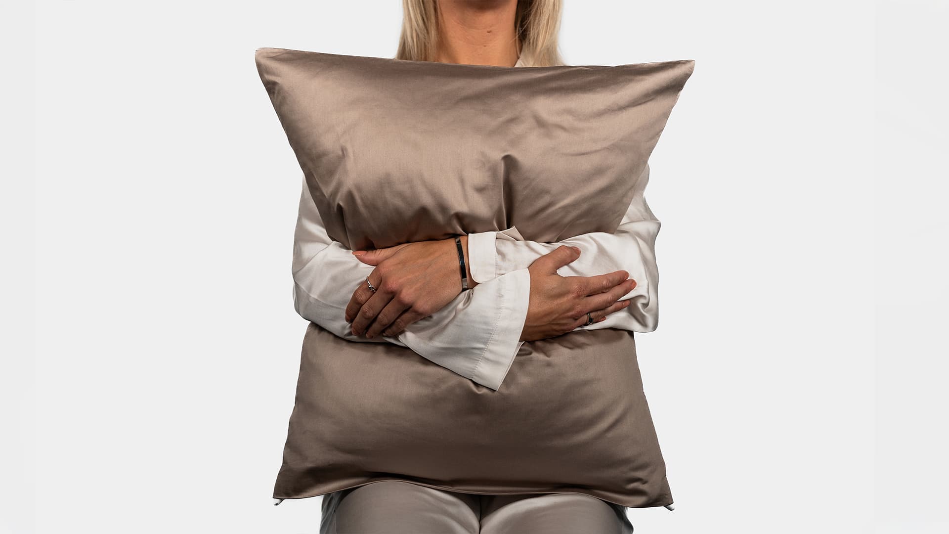 woman model holding a pillow while sitting